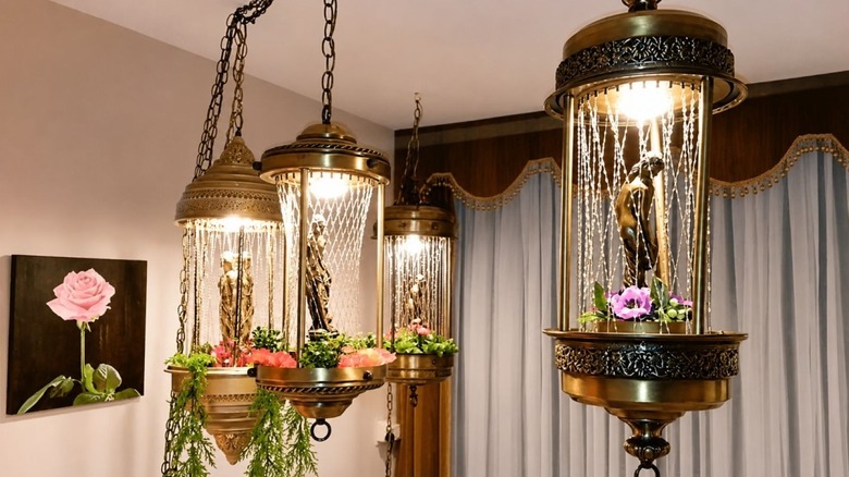 Several vintage rain lamps hanging in a room