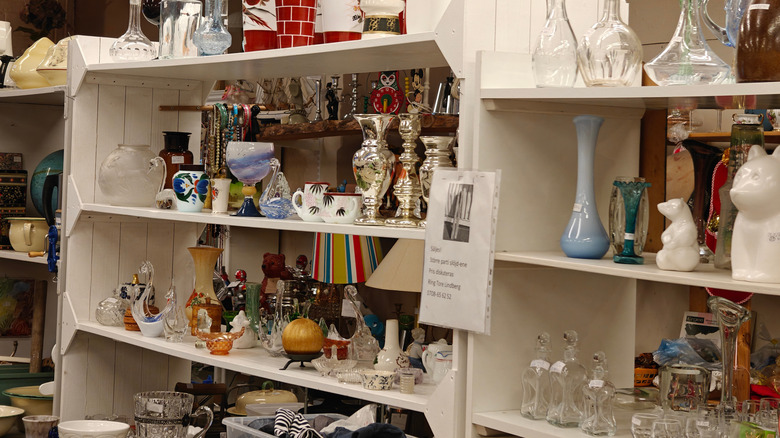 Glassware, vases, and more on shelves in a thrift shop