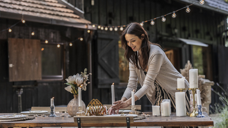 A person setting a table for a dinner party