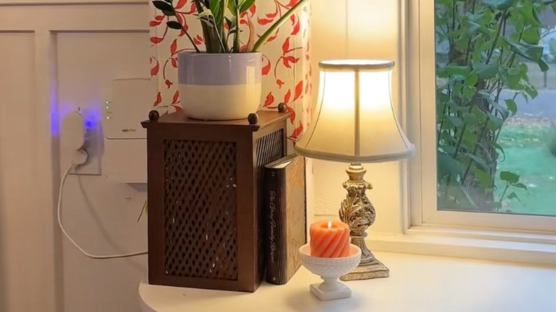 Modem cover made from wooden magazine file placed upside-down