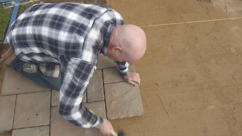 Man installing precast pavers