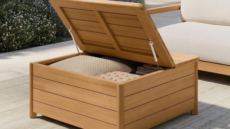 Article Elise Outdoor Storage Coffee Table open top with outdoor cushions inside