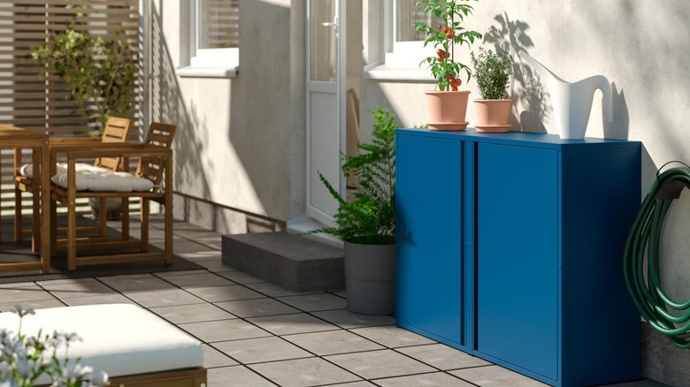 Blue IKEA SUNDSÖ Cabinet against home exterior on outdoor deck