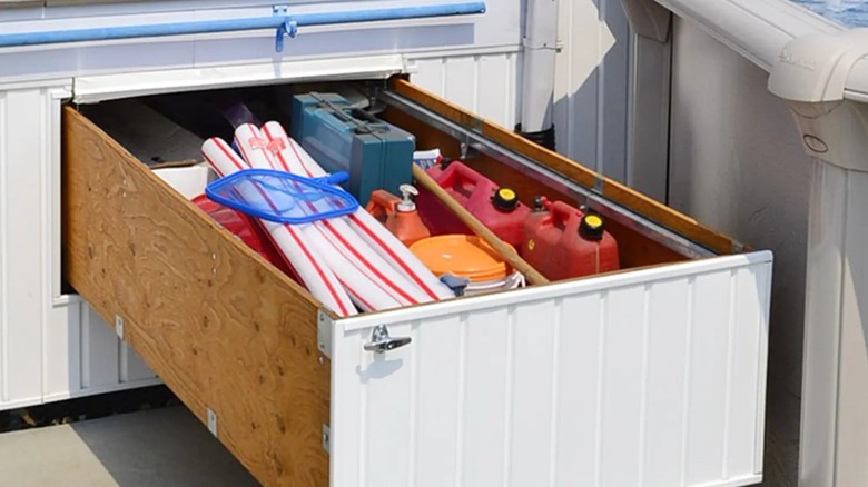 Open Pylex Deck Storage Drawer in deck area next to backyard pool