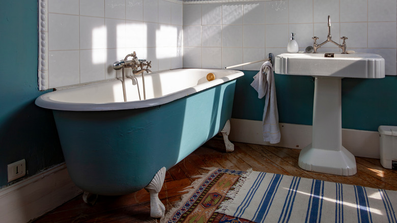 Vintage clawfoot tub painted teal.