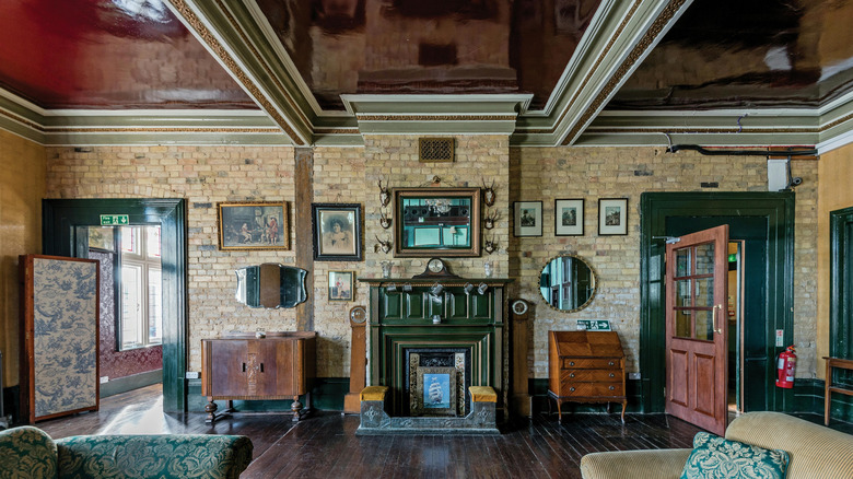 Historic living room with ornate crown and ceiling molding.