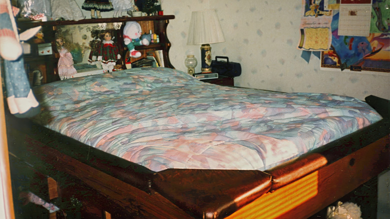 An old bedroom with a waterbed in a wood frame