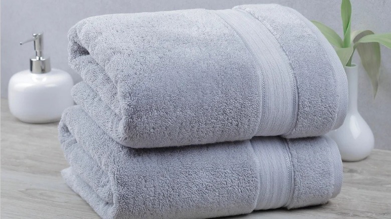 Costco's large bath sheets, neatly folded in a stack of two, in the color silver.