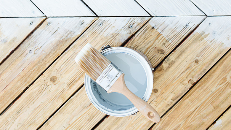 Paintbrush on painted wood flooring