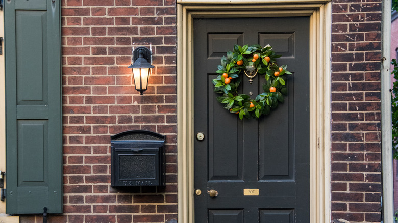 front porch of home with black front door