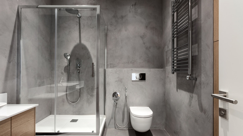 A gray bathroom with standing shower