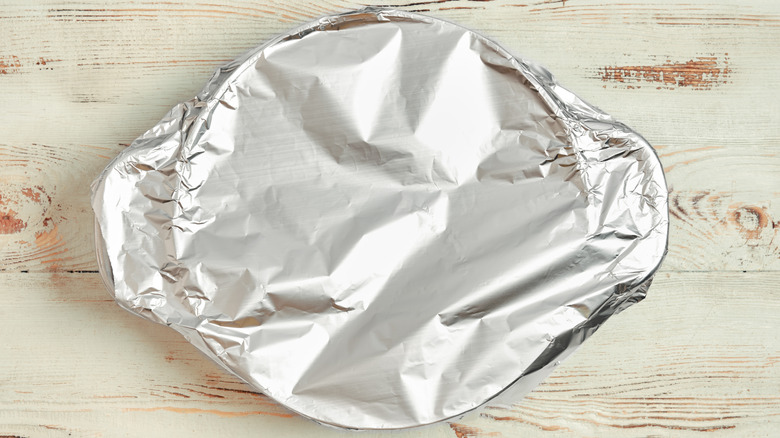 A piece of bakeware covered in a layer of aluminum foil