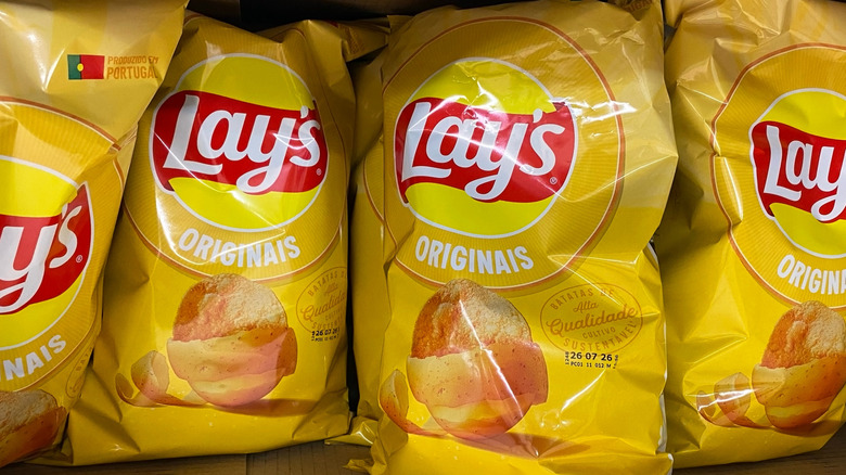 Yellow Lay's potato chip bags lined up on store shelf