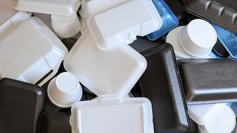 A pile of differently-sized and colored styrofoam food containers