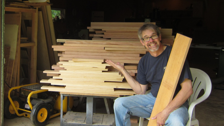 the author with a large pile of lumber