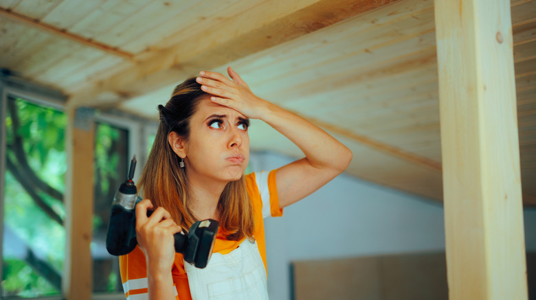 Woman frustrated with power drill