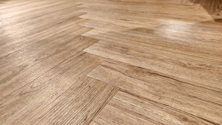 Close-up of laminate flooring, its grain-like texture, and its sheen