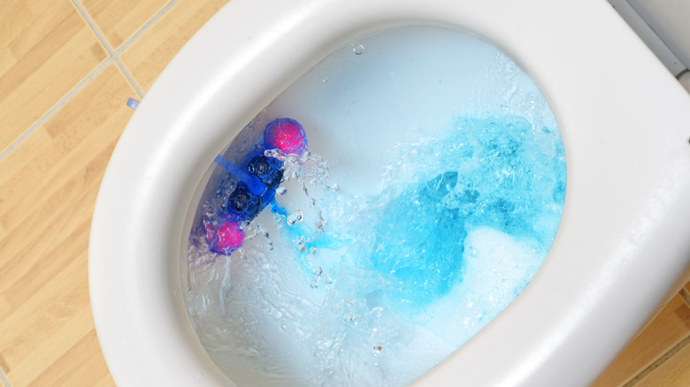 Toilet cleaning balls hooked on side of toilet