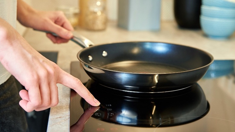 Person cooking on an induction cooktop