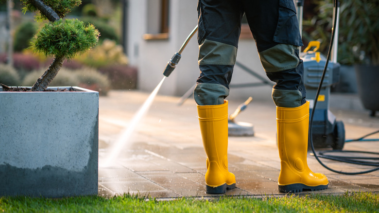 Person pressure washing their patio