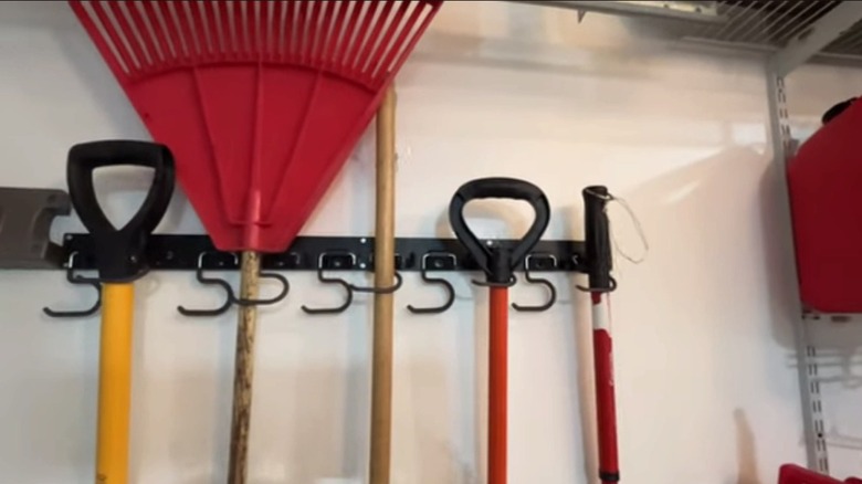 Yukon multipurpose wall-mount tool organizer hangs rake, shovels, and other items in garage