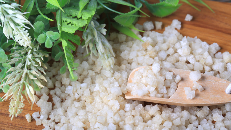 leaves and Epsom salts scattered on a wooden board