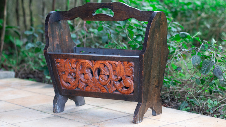Carved wooden magazine rack