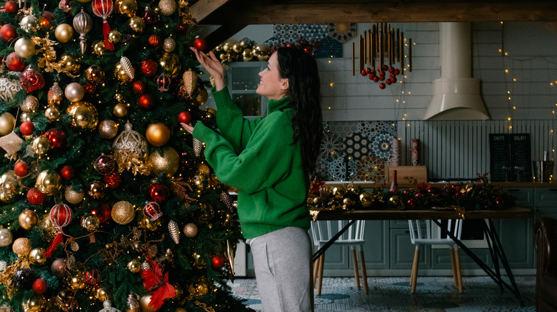 Woman decorating a stunning Christmas tree