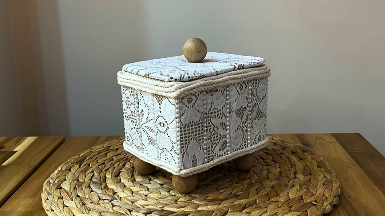 Box made out of flattened toilet paper tubes and covered with lace