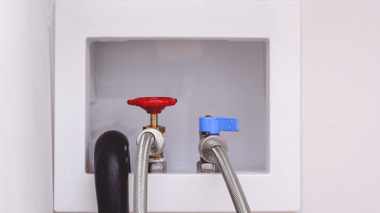 A washer hookup in a wall