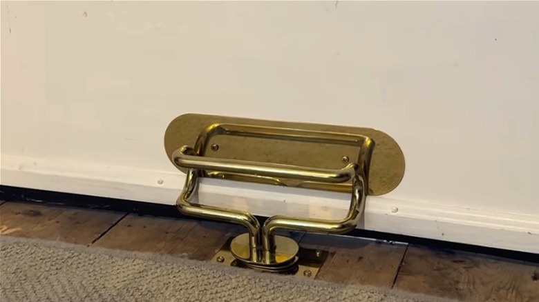 A Door Club inserted into the floor to block door from opening