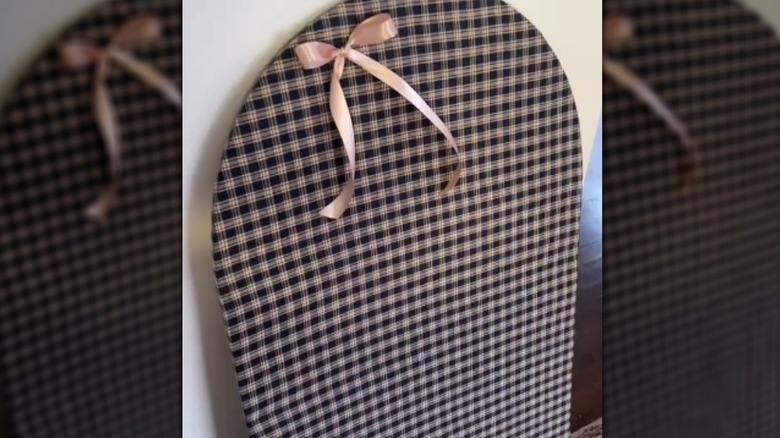 Plaid covered arch corkboard with bow