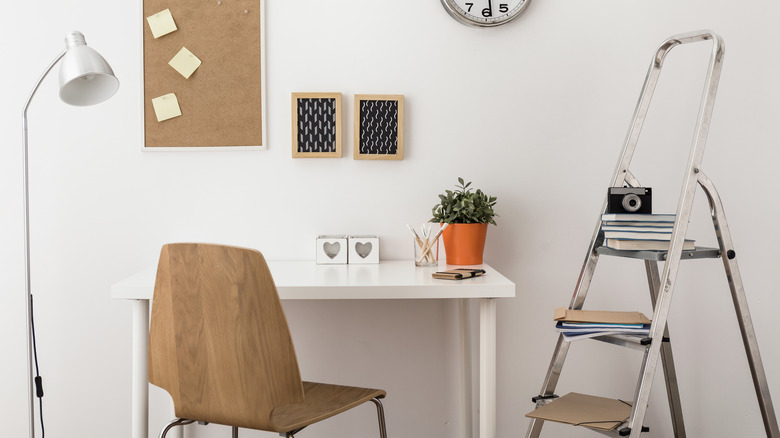 Home office with ladder shelves and corkboard