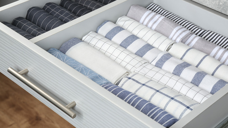 A drawer of neatly rolled kitchen towels