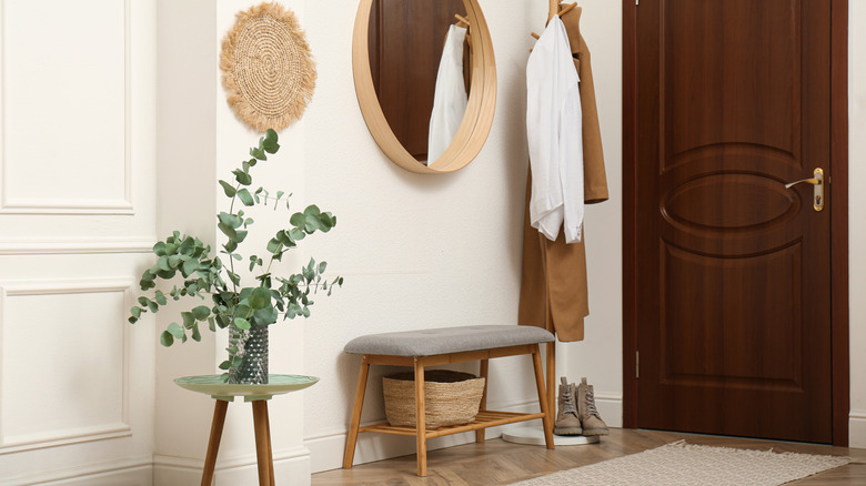 modern entryway with a bland, basic upholstered bench