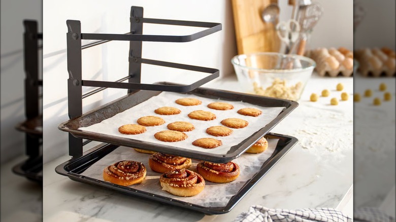 Baked goods lay on cookie trays stacked on a SVARTABBORREE Baking sheet rack from IKEA