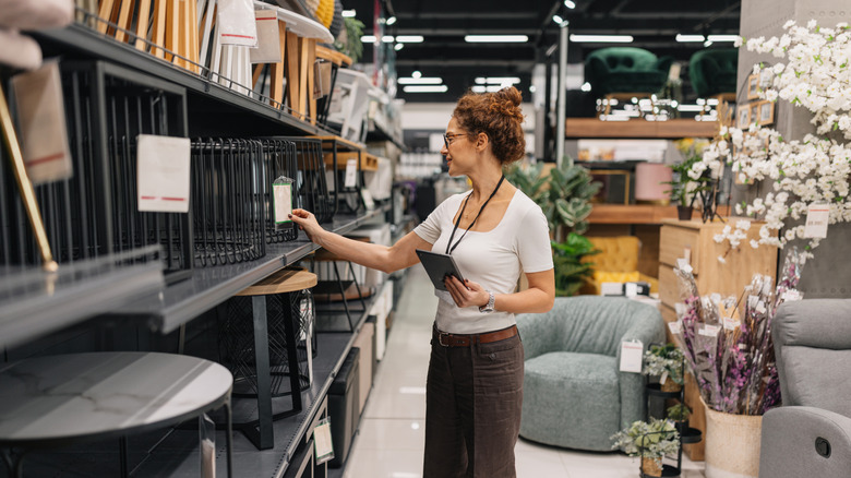 Woman browsing side tables in a store