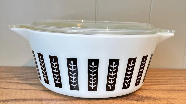 The Pyrex Gourmet black leaf 2.5-quart casserole dish on a wooden surface