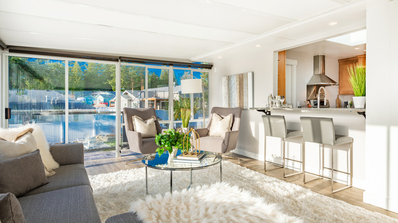 A modern living room with a pass-through window breakfast bar to the kitchen
