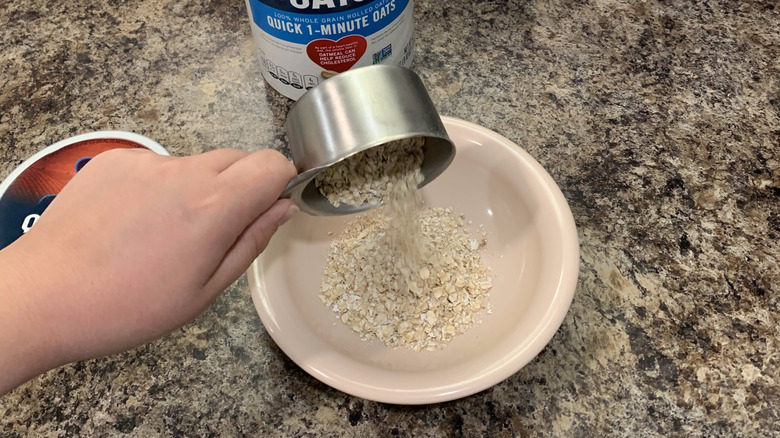 pouring oats into bowl