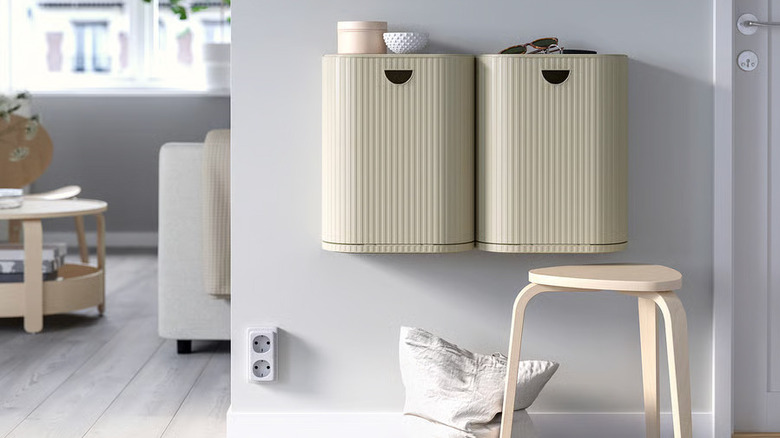Two IKEA GÅRDSBUTIK bins are installed next to each other on a gray wall
