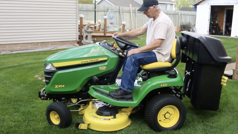 Man riding the John Deere X354 on his lawn