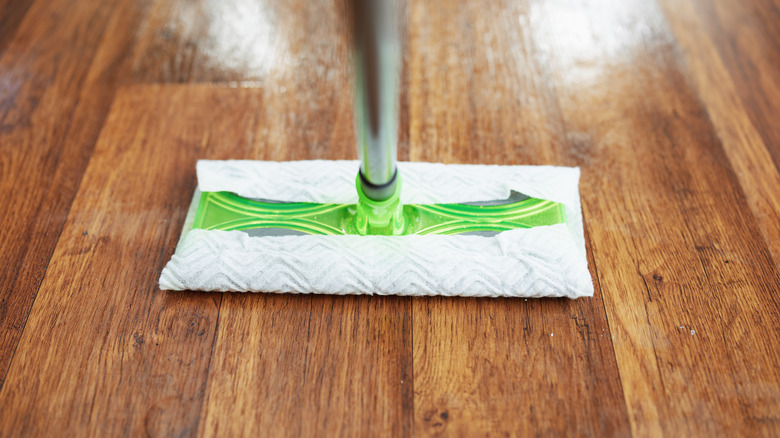 using a lightweight Swiffer mop on a wooden floor