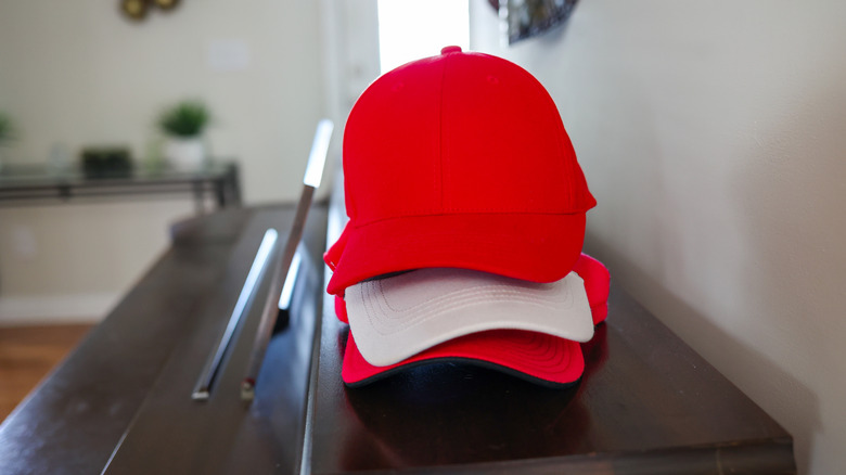 stack of baseball caps