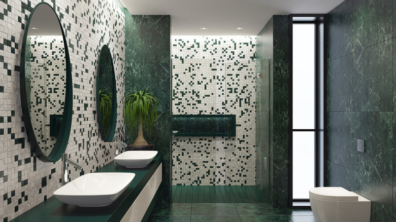 a modern bathroom with green wall and floor tiles
