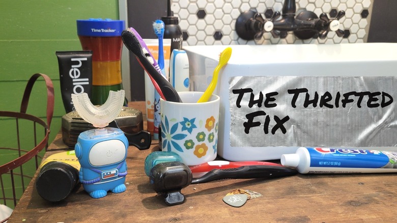 Toothbrushes, toothpaste, and other dental care items scattered across the bathroom counter
