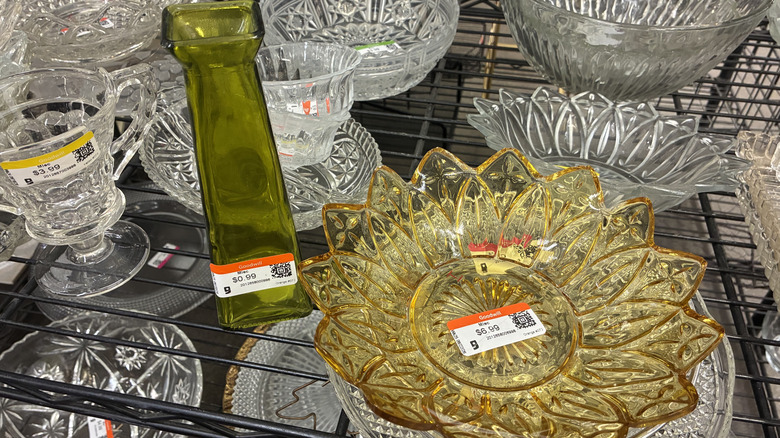 Flower bowl and green vase on houseware shelf of Goodwill