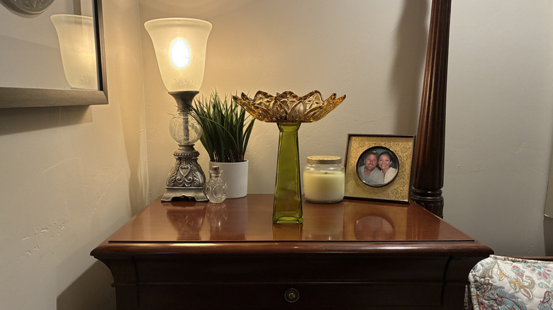 Completed flower catchall dish made from thrift store items sitting on a dresser