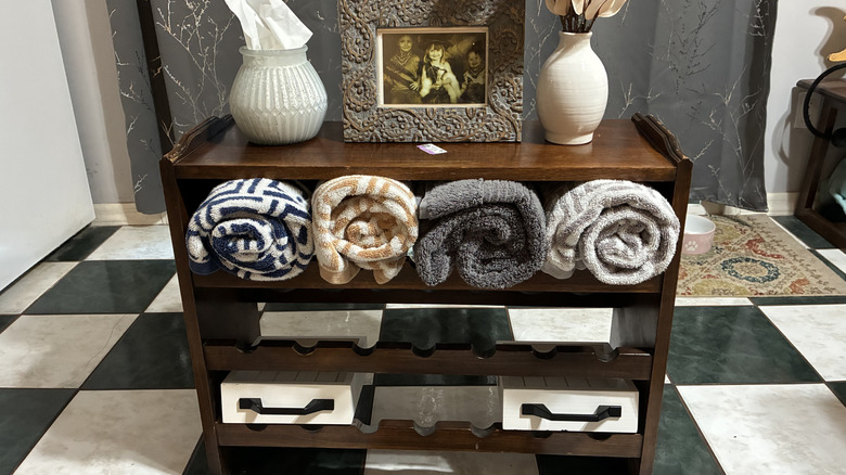 Old wooden wine rack turned into bathroom organizer