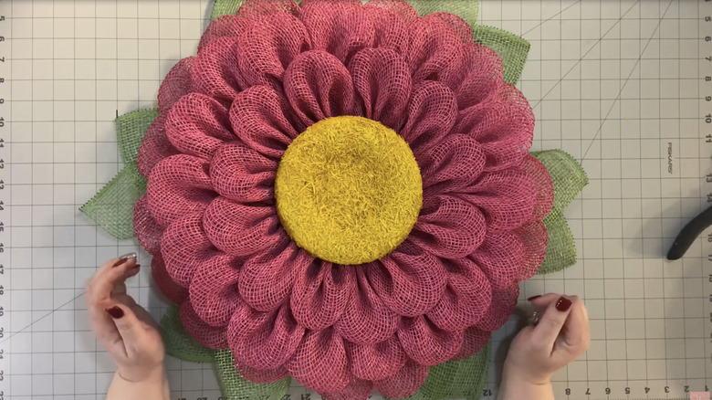 A pink flower wreath made of burlap